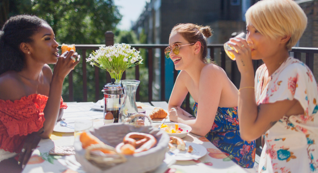 Group of friends toasting mimosas at brunch, celebrating Galentine’s Day in Bluffton & Hilton Head.